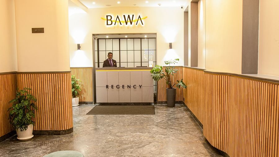 A long view of the lobby area at Hotel Bawa Regency, Dadar, showcasing the reception area.