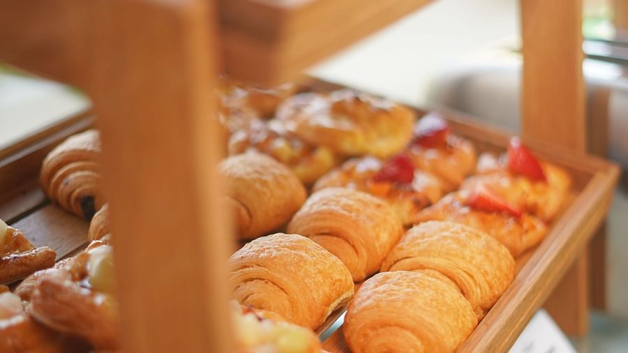 many baked items kept on a double tiered tray - La Maison Hotel, Doha