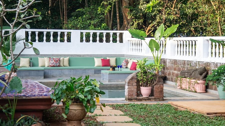 Stone path way in a green lawn @ Lamrin Ucassaim Hotel, Goa