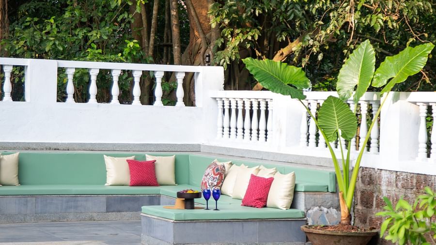 pool with red and white pillows @ Lamrin Ucassaim Hotel, Goa
