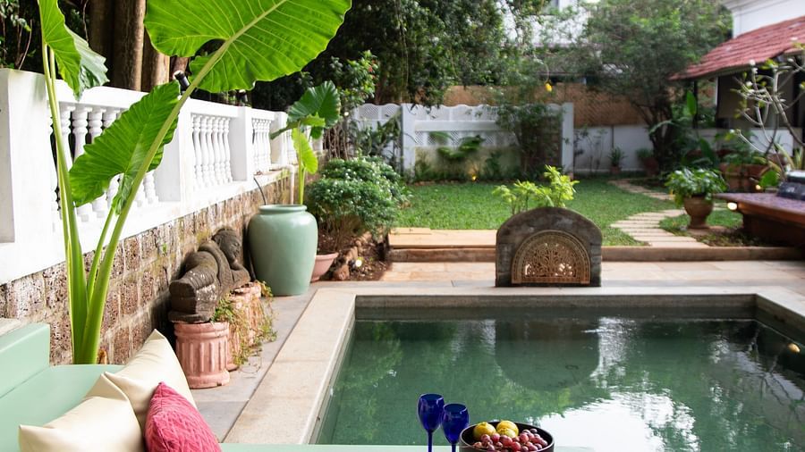 Pool with red and white cushions @ Lamrin Ucassaim Hotel, Goa