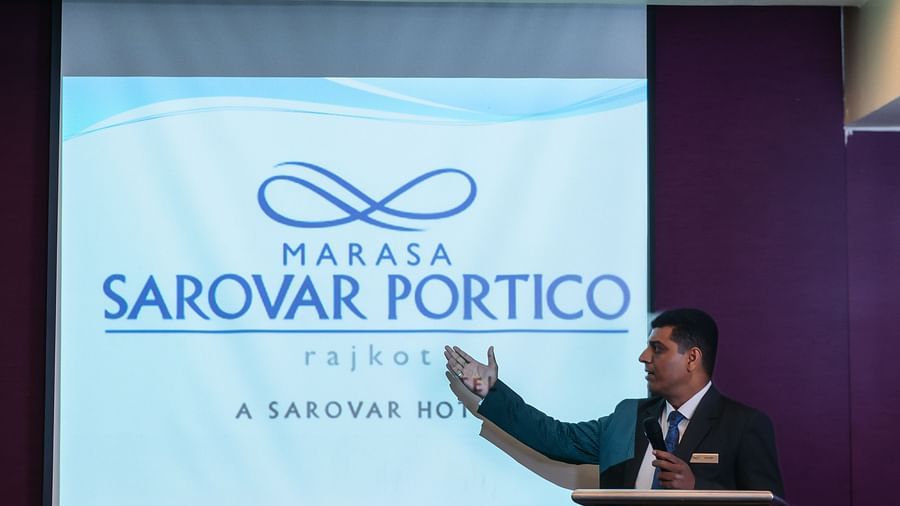  A man presenting the at banquet hall in Marasa Sarovar Portico, Rajkot