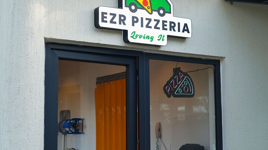 Exterior entrance view of Ezr and Bar with visible signage and tiled roof.