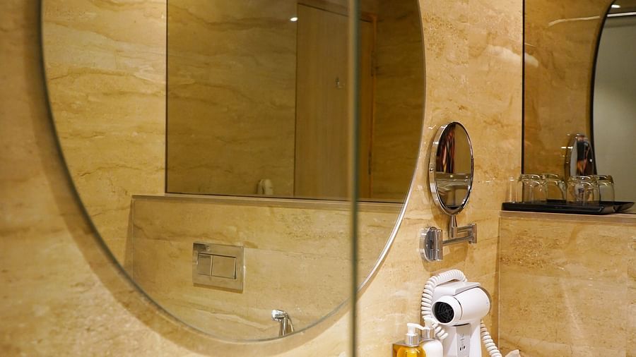 Modern bathroom at Nemesia featuring a large mirror and stylish fixtures.