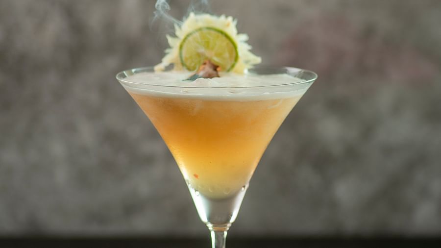 a glass of yellow drink - polo floatel kolkata