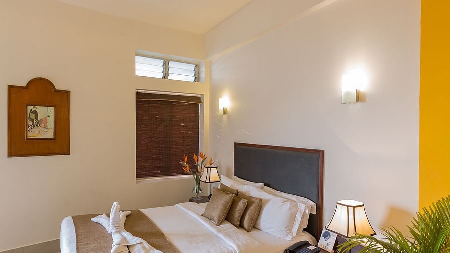 a room with a bed and work station on one side