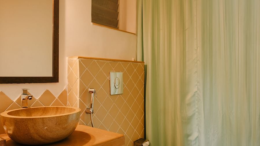 Well-lit bathroom with stylish interiors at One BHK Apartment, Richmonde Ananta Elite, Goa.