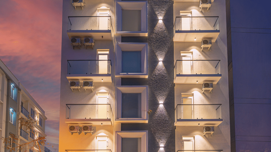 Modern hotel facade illuminated at night with contemporary architecture at Rivido - Manyata.