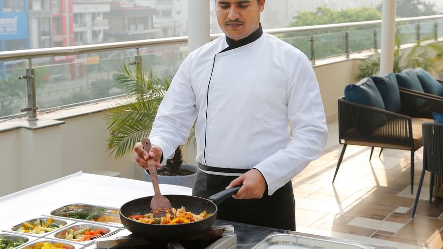 Sapna Clarks - a chef cooking at the rooftop