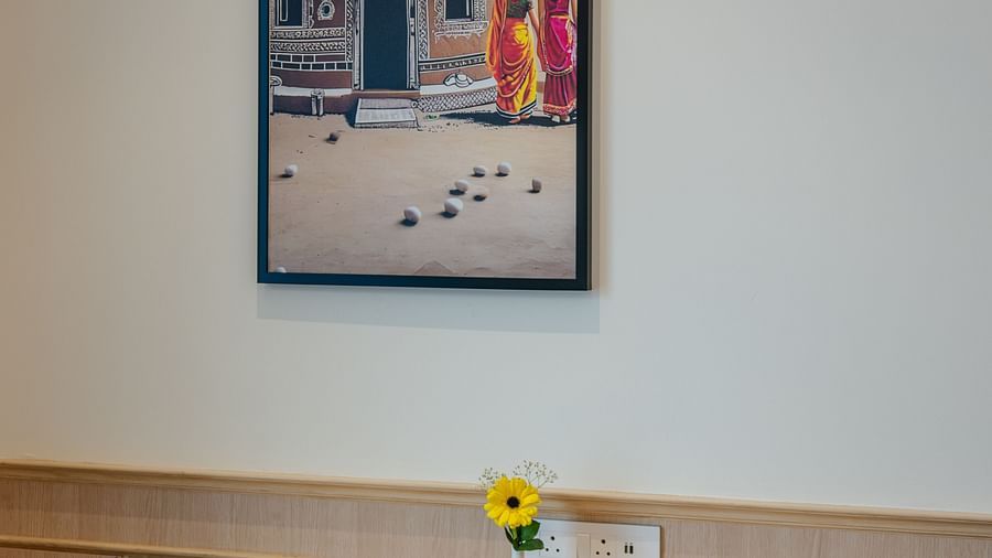 A writing desk in our junior suite featuring a blue chair placed in front of it - Sarovar Portico, Ajmer