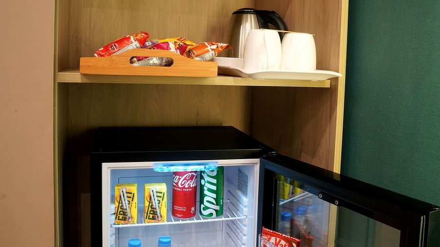 view of the minibar, snacks, and a tea and coffee maker in one of the rooms at Sarovar Portico, Kolkata Rajarhat