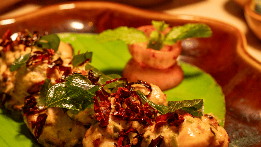Close-up of a grilled appetiser served on a plate with garnish - Symphony Resorts