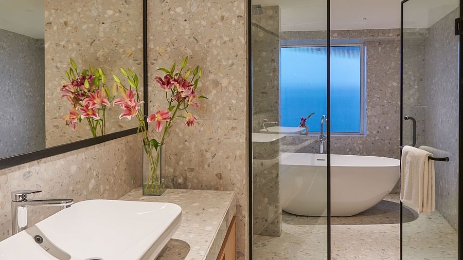 Image of a washroom with a glass door saperating the bath area - The Dukes Retreat, Khandala