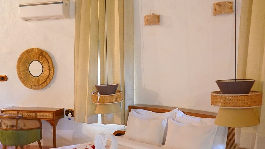 Ethnic theme room with large bed and minimal decors  at Themis Mudhouse Nature Retreat Resort