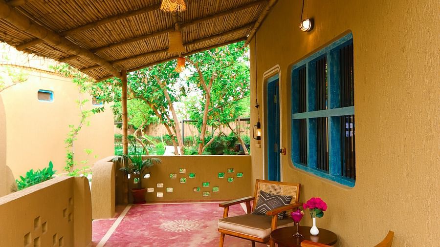 lobby of a villa with chairs placed in it at Themis Mudhouse - A Nature's Retreat Resort & Wellness