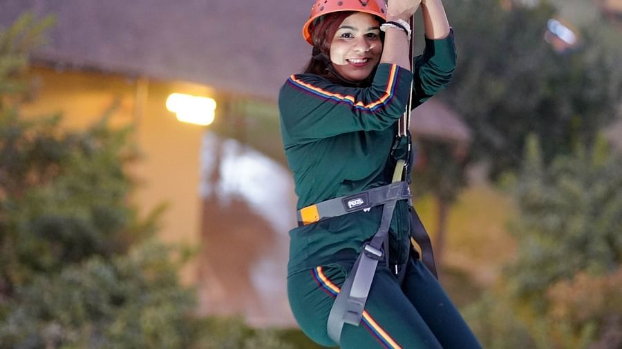 A woman zip lining at Themis Mudhouse - A Nature's Retreat Resort & Wellness