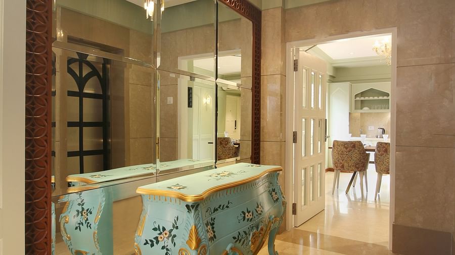 antique furniture and expansive mirror at theory9 bandra