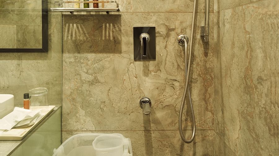 shower area in the bathroom of one of the rooms at Triptam Hotel, Vrindavan