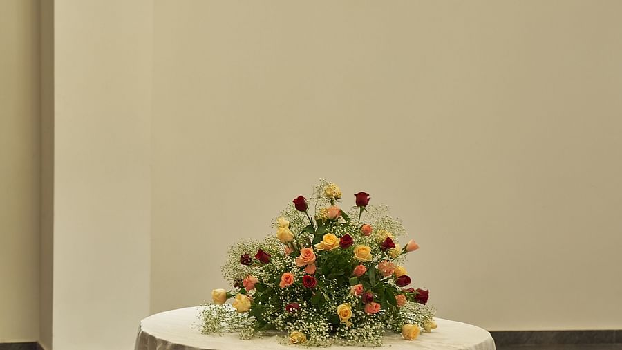 a table with flower decorations at Prangan banquet hall at Triptam Hotel, Vrindavan