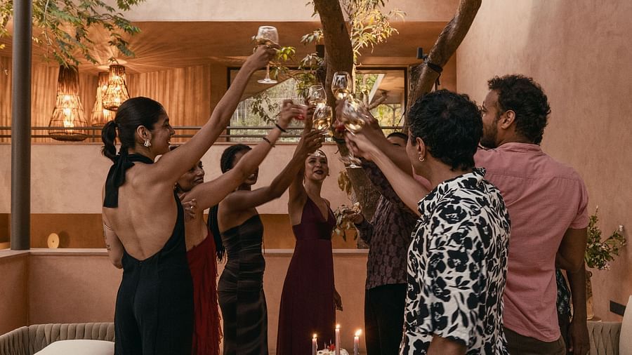 A group of people raising a toast with wine glasses at Villa Moira by V Escapes.