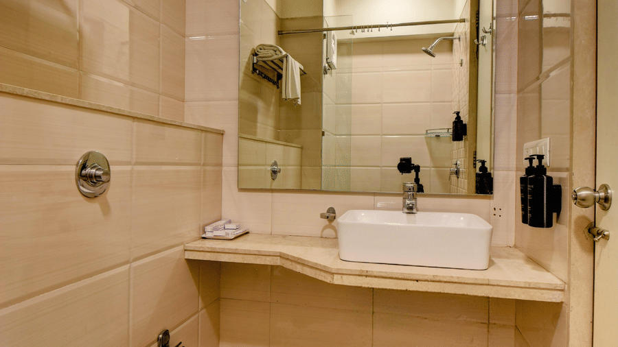 Clean bathroom with washbasin, mirror, and modern fittings at VITS Lonavala.