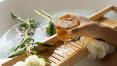 a woman holding a drink during a calming bath at the spa resorts in Goa, Azaya