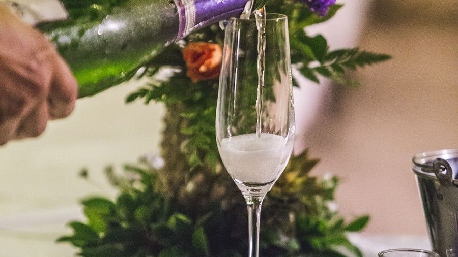 image of a person pouring sparkling wine in a glass - Maikhao Dream Villa Resort & Spa, Phuket 