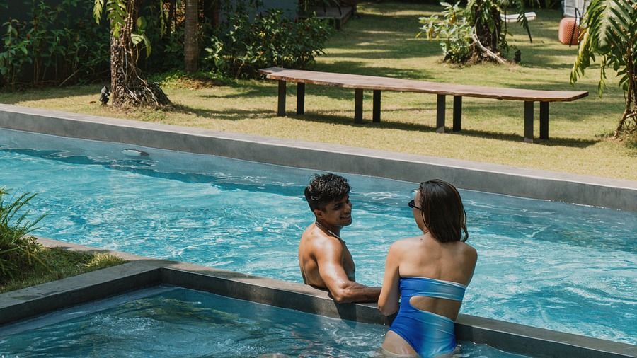 The couple enjoying a refreshing swim together in the pool
