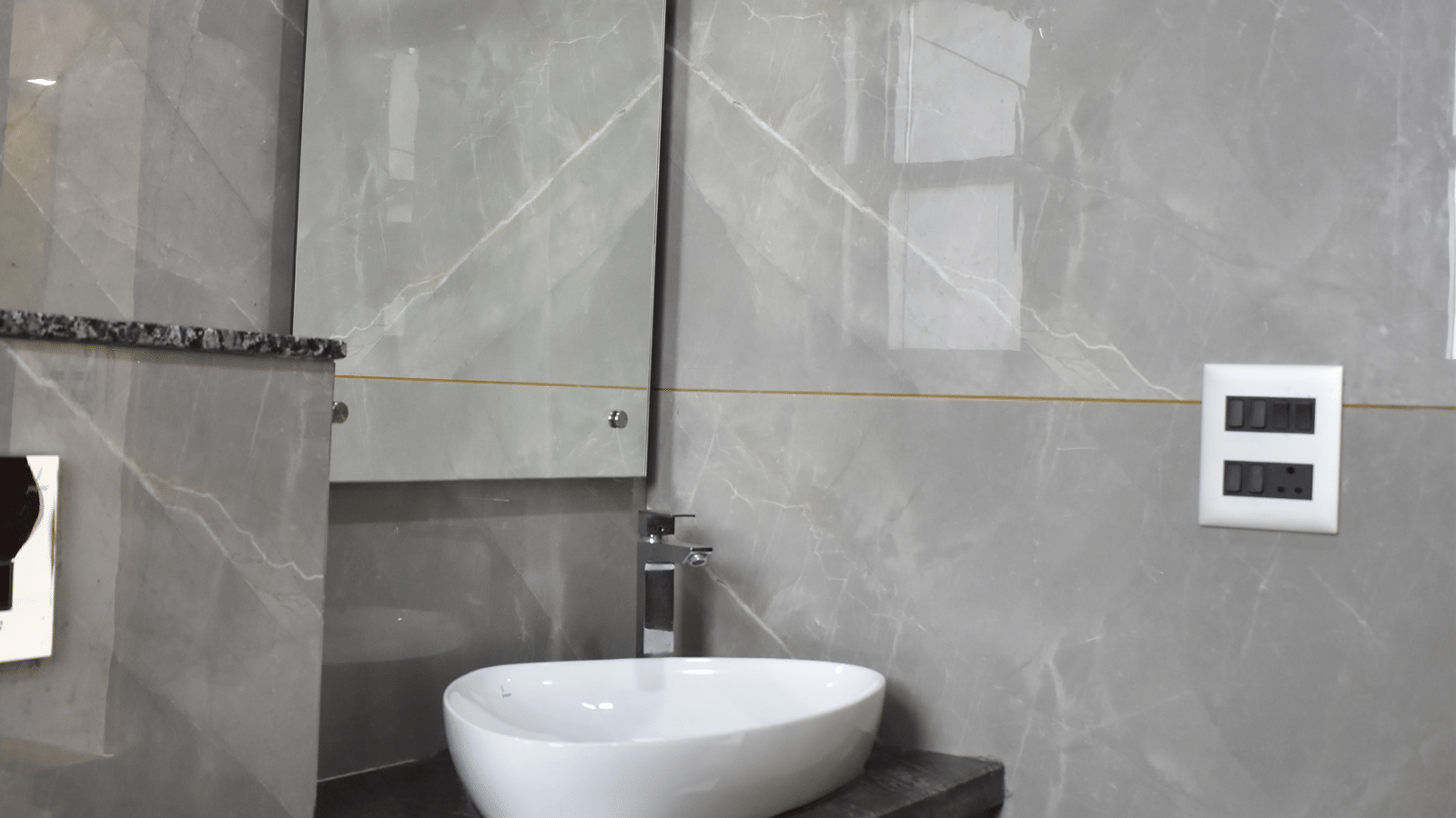 Bathroom vanity unit with a white basin and mirror in a room at Lime Tree Hotel Near Medanta.