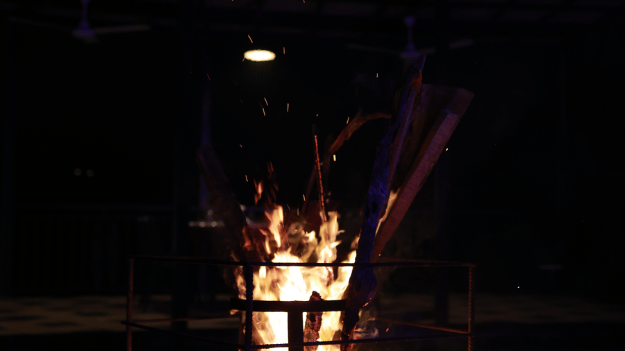 A bonfire lit on a protected platform that is a bit higher than the ground at Aveda Mountains and Mist Resort and Spa, Munnar.