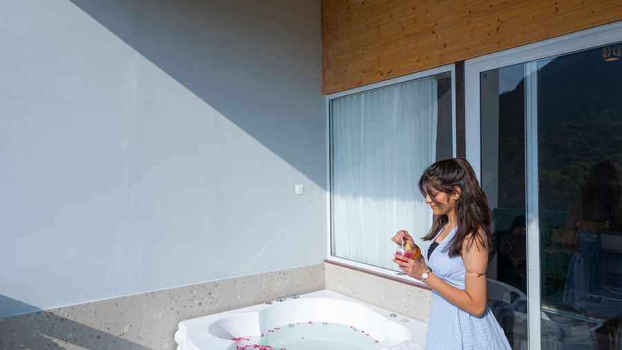 A woman walking at the Sajjan Villa Balcony at Bamboo Saa Resort and Spa, Udaipur.