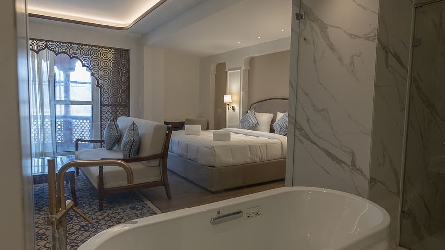 A close up shot of the bathtub overlooking the Purna Room at Bhagirathi by RDB Atishay through the glass partition.