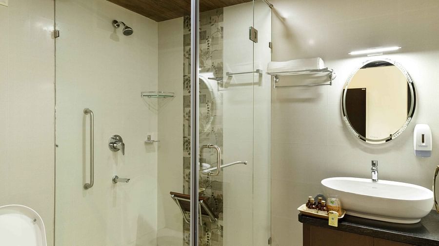 A modern bathroom with a glass-enclosed shower and a sink.