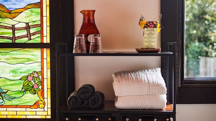 A stained-glass window casting vibrant colors into the spa room at The Pavilion, Brewery Gulch Inn & Spa