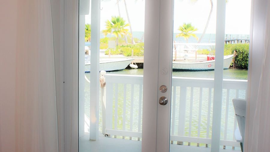 a bedroom at casa morada with a glass door overlooking the garden. 