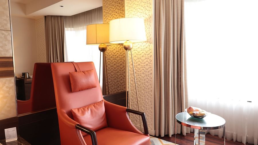 A cushioned chair with a small cushioned table in front of it | Cenneys Gateway