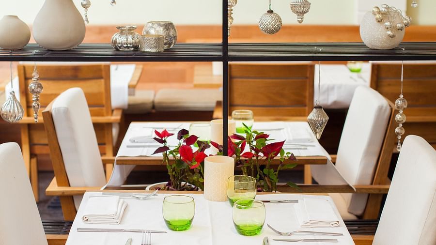 A small dining area is visible with a table and chairs | The Shop | Central Mansions, Phnom Penh