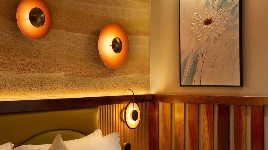 Image of Coral Sapphire at Coral Reef Resort and Spa in Havelock featuring a plush bed under warm lighting and a wall painting next to it on the wall