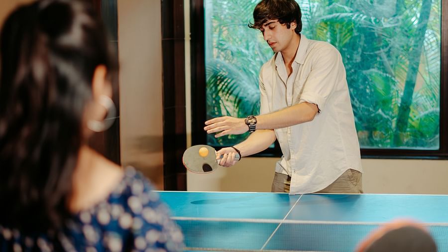A boy and girl playing a game of table tennis against each other at Crescent spa & resort, Indore
