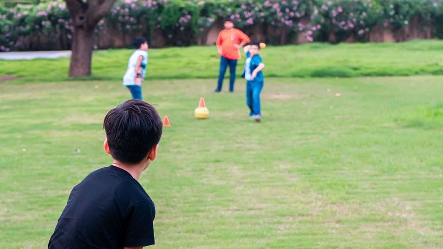 A group of boys playing cricket in the play area at Crescent Spa & Resort, Indore