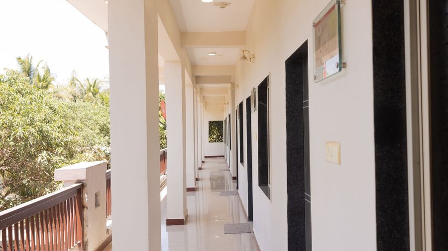 A porch area along the rooms at Daksh Resort & Amusement Park, Sasan Gir.