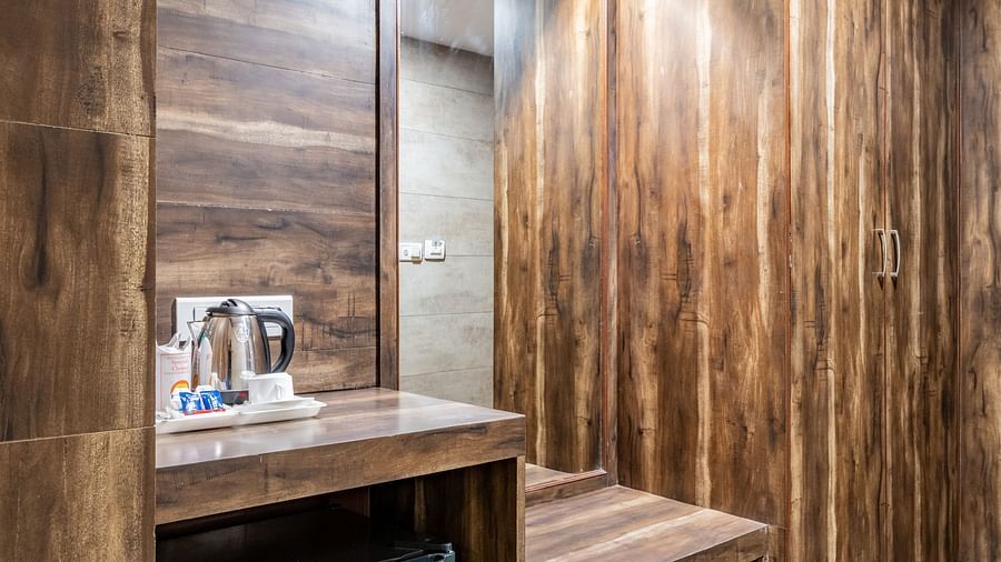 Wooden structure comprising of the wardrobe, a mirror, the minibar and tea & coffee maker in the Maharaja Deluxe Room of Hotel Highway King, Behror.