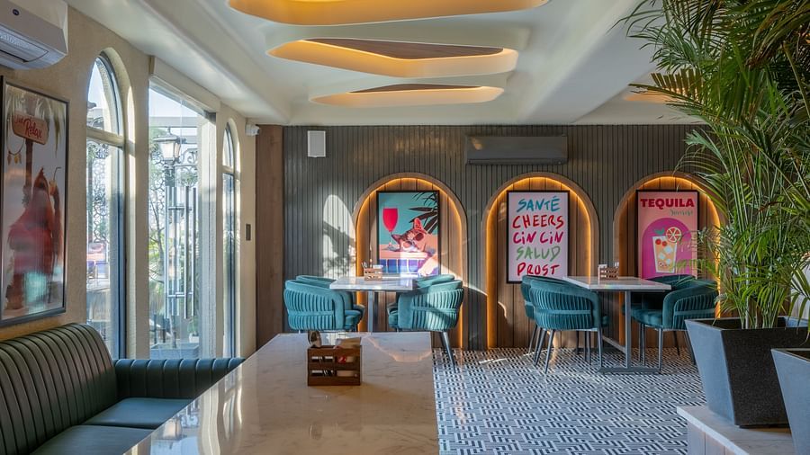 Entry view of restaurant with black tiled floor and ceiling lights at Hotel Highway King, Jaipur.