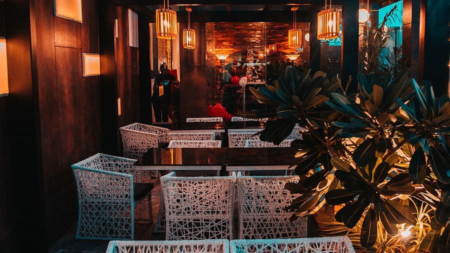 view of the interior of a rooftop restaurant with tables and chairs in clusters - Hotel Park Elanza, Chennai