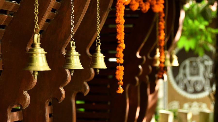 image of bronze bells with bright sunlightat Hoysala Village Resort, Hassan