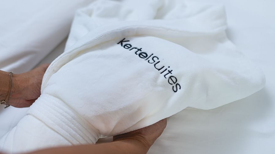image of a white coloured towel being wrapped with Kertel Suites written on it