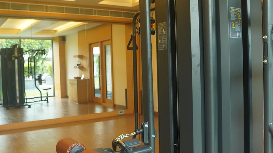 Multi-purpose gym equipment is positioned near the window