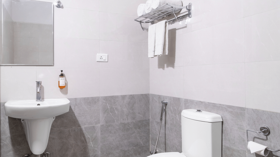 Washroom with mounted mirror and a sink at Lemonridge by Monday Hotels - Kukatpally.