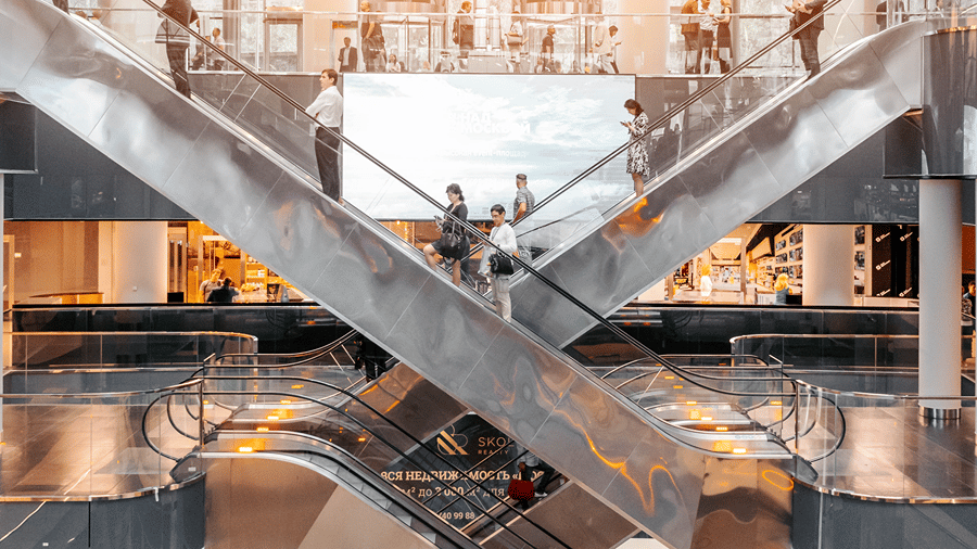 Interior view of crisscrossing escalators inside a building.