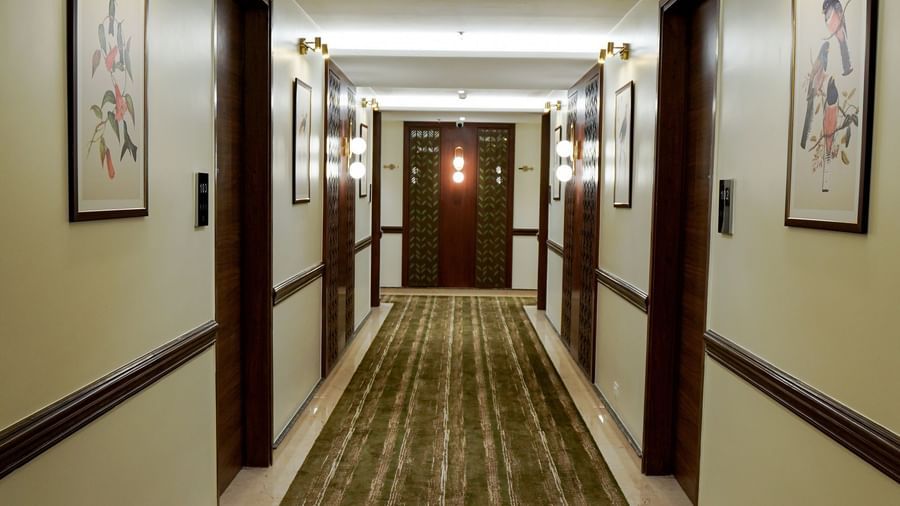 The expansive corridor at M2 Square by Monday Premium featuring several paintings hung on the wall opposite to each other.